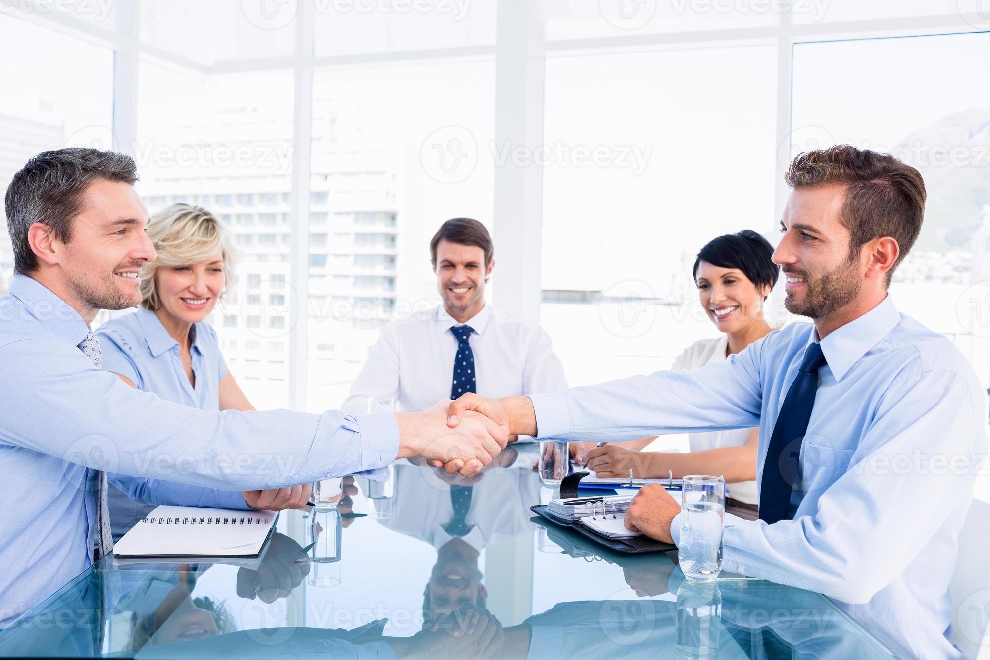 executives-shaking-hands-during-business-meeting-photo
